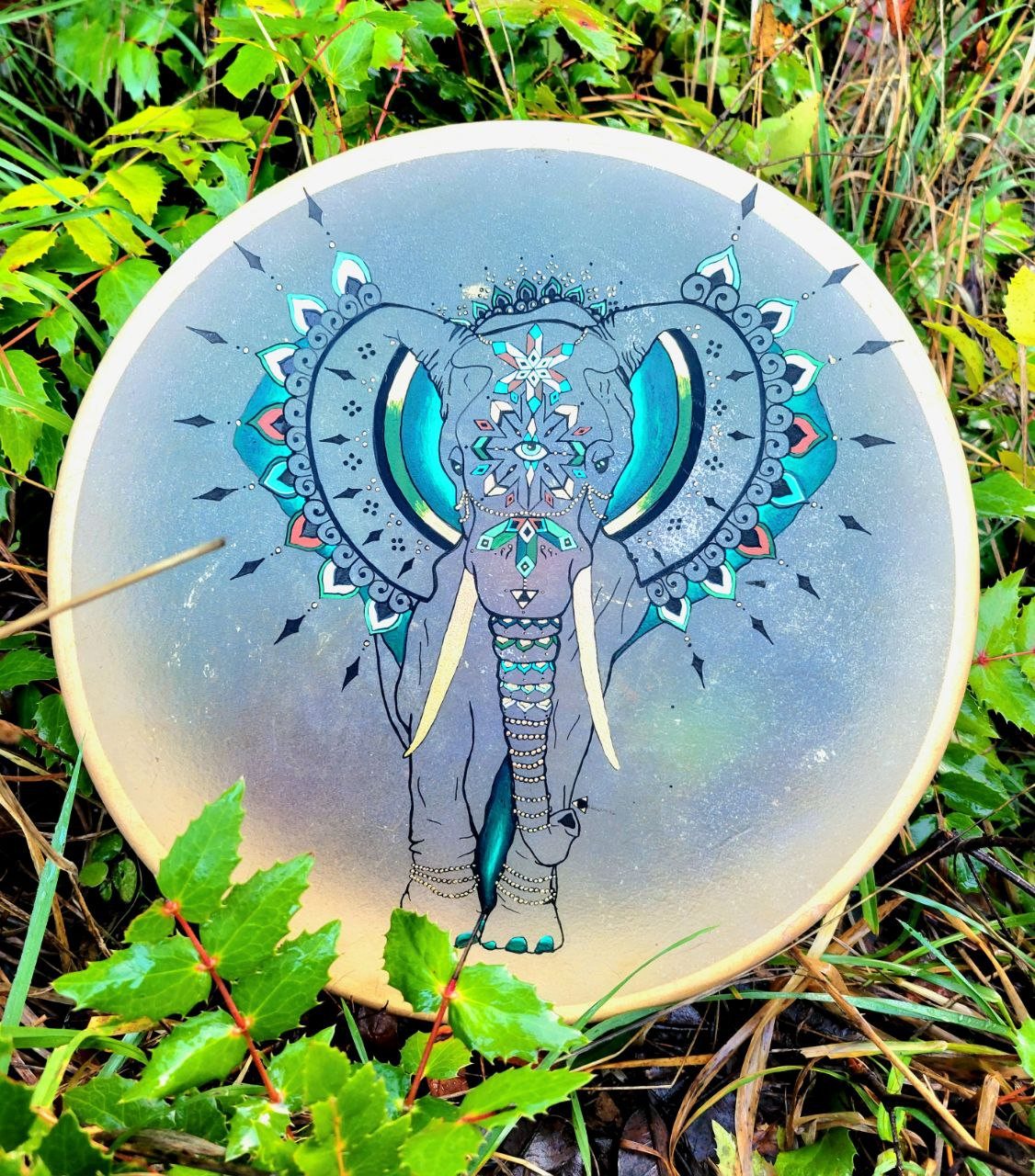 Hand drum painted with a turquoise mandala elephant