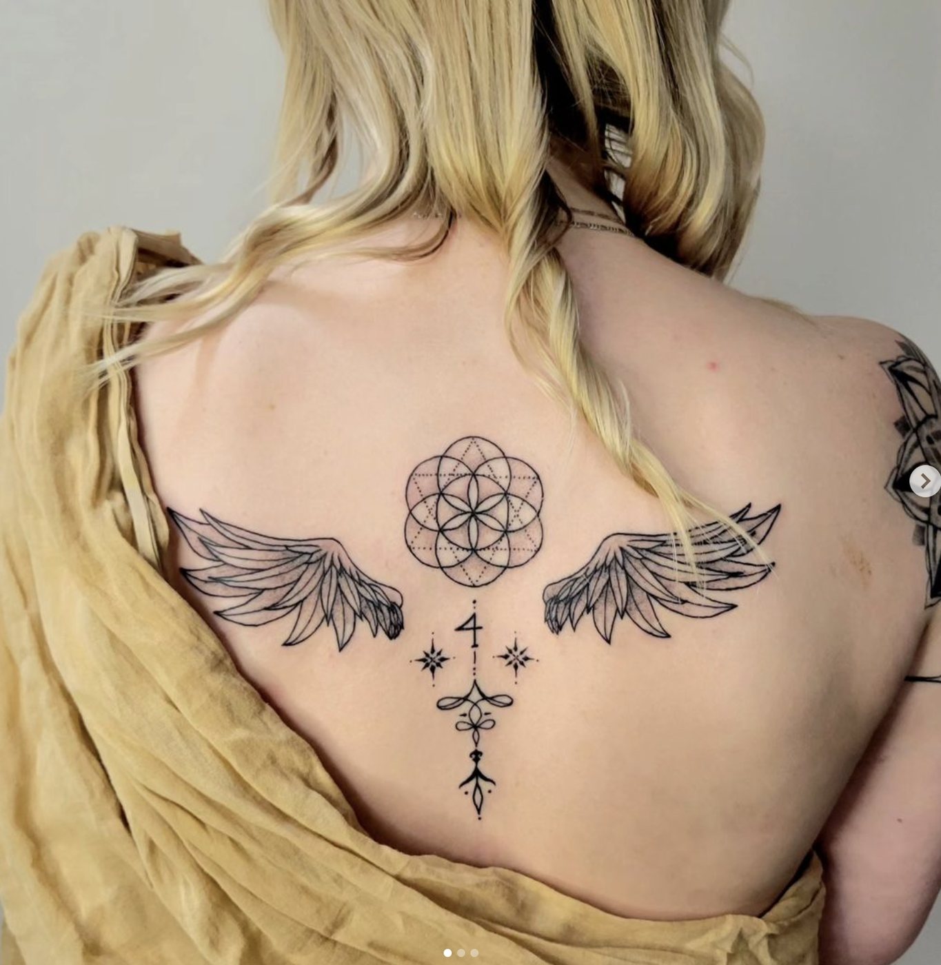 Flower of life and wings back tattoo