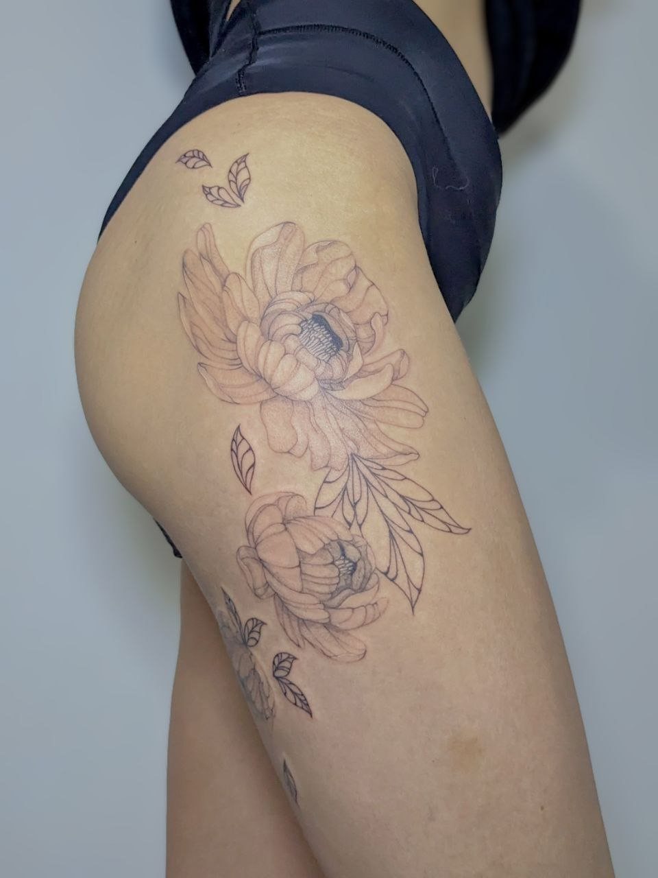 Fine-line peony tattoo